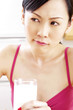 Disgruntled woman holding a glass of milk.
