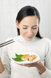 Woman eating japanese cuisine.