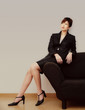 Businesswoman posing on the couch.