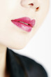 Close-up on woman's lips with lipstick applied.