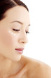 Foto: Woman with three dots of moisturiser across her cheek. Woman with three dots of moisturiser across her cheek.