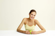 Woman holding a green apple.