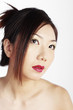 Woman with makeup looking up.