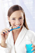 Woman brushing her teeth.