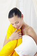 Woman hugging two pillows.