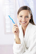 Woman holding toothbrush.
