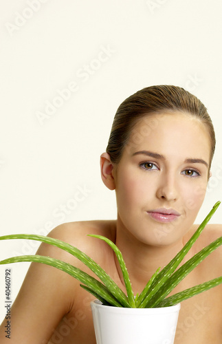 Photo: Woman posing with a pot of aloe vera. Woman posing with a pot of aloe vera.