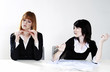 Photo: Businesswoman getting frustrated with her colleague for not doing her work. Businesswoman getting frustrated with her colleague for not doing her work.