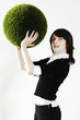 Businesswoman holding a grass ball.