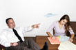 Businessman playing with paper plane while his colleague is busy working.