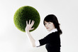 Businesswoman holding a grass ball.