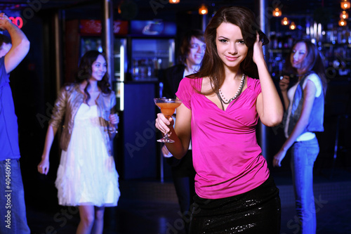 Photo: Young woman having fun at nightclub disco Young woman having fun at nightclub disco