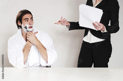 Photo: Businessman shaving his beard in the office. Businessman shaving his beard in the office.