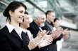 Corporate people clapping hands.