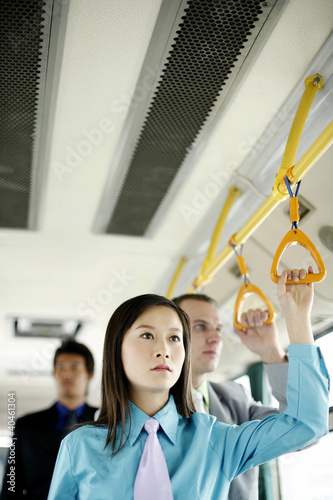 Photo: Working people standing in a train. Working people standing in a train.