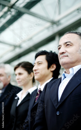 Photo: Corporate people standing in a row. Corporate people standing in a row.