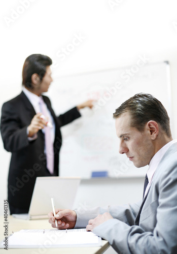 Photo: Businessman taking down some important notes. Businessman taking down some important notes.