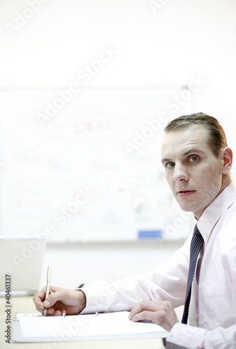 Photo: Businessman taking down some important notes. Businessman taking down some important notes.