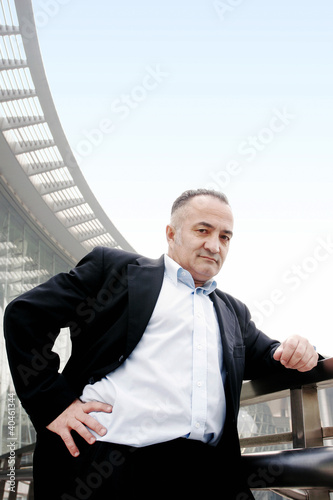 Photo: Senior businessman posing for the camera. Senior businessman posing for the camera.