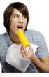 Man with napkin eating corn.