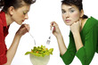 Photo: Two women sharing a bowl of salad. Two women sharing a bowl of salad.