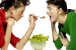 Photo: Woman feeding her friend. Woman feeding her friend.