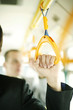 Photo: Hand holding on to the train handle. Hand holding on to the train handle.