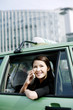 Photo: Businesswoman talking on the handphone in the taxi. Businesswoman talking on the handphone in the taxi.
