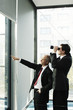 Photo: Businessman using binoculars. Businessman using binoculars.