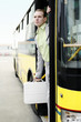 Businessman getting down from a bus.