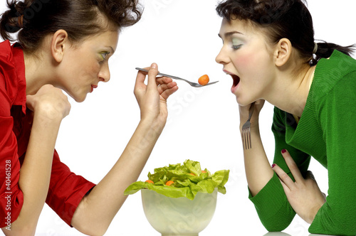 Foto: Woman feeding her friend. Woman feeding her friend.