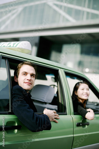 Photo: Businessman and businesswoman in the taxi. Businessman and businesswoman in the taxi.
