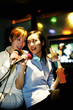 Women singing in the karaoke lounge.
