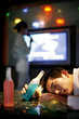 Drunk man sleeping in the karaoke lounge.