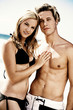 Couple in swimsuit posing for the camera.