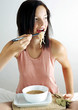 Woman eating a bowl of noodles.