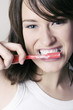 Woman brushing her teeth.