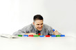 Businessman playing with plastic blocks.