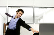Businessman running in to save his computer.