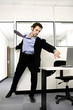 Businessman running in to save his computer.