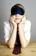 Businesswoman covering her eyes with an eye mask.