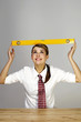 Businesswoman placing a spirit level on her head.
