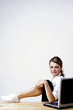 Businesswoman shaving her leg while working in the office.