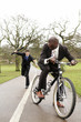 Businessman trying to beat another businessman with an umbrella.