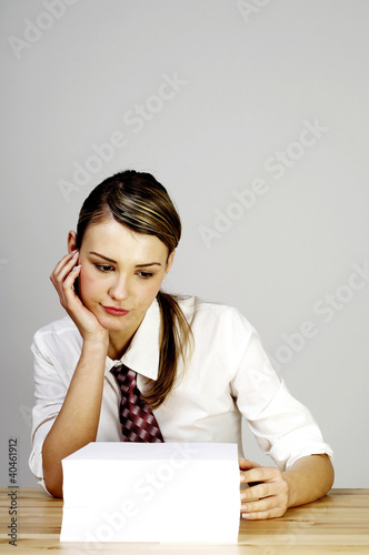 Photo: Businesswoman with a stack of paper works. Businesswoman with a stack of paper works.