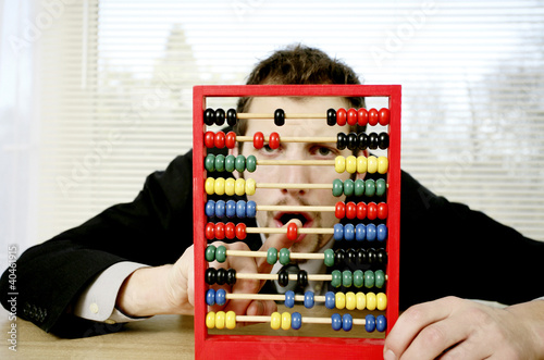 Photo: Businessman playing with children abacus. Businessman playing with children abacus.