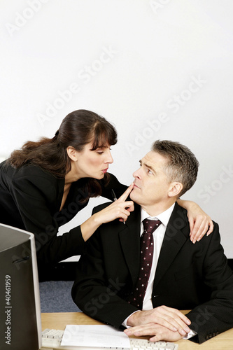 Photo: Businesswoman asking her superior to keep secret. Businesswoman asking her superior to keep secret.