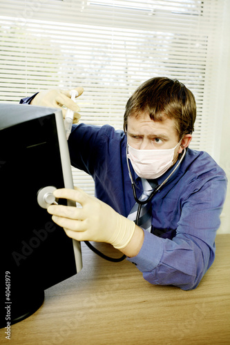 Photo: Businessman saving his computer from virus. Businessman saving his computer from virus.