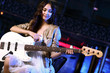 Young guitar player performing in night club
