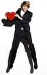 Businessman holding a red heart.